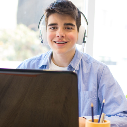 teenager with computer and headphones